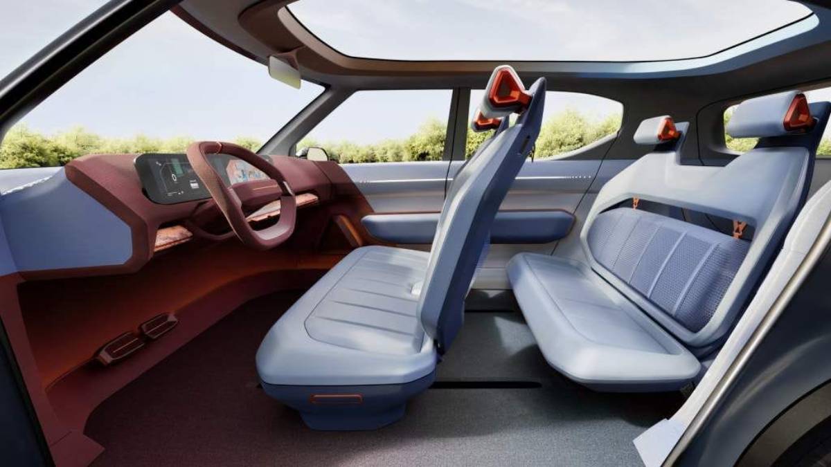 Futuristic car interior featuring sleek blue and red seats, a minimalist dashboard, and large windows with an open, airy feel.