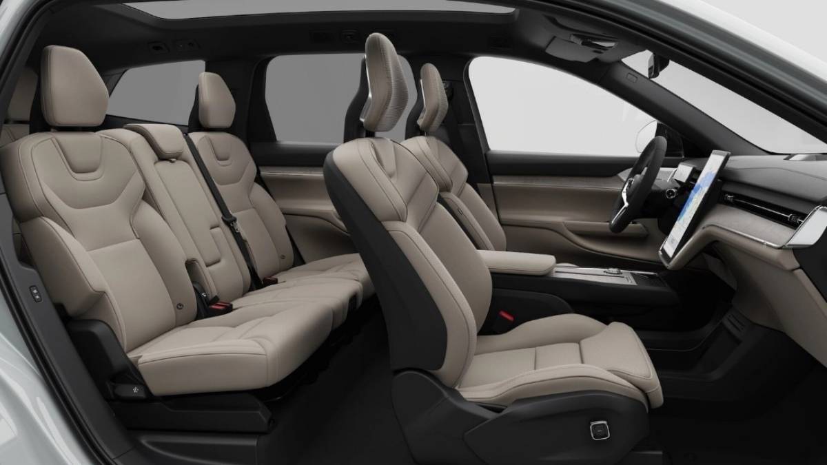Interior view of a modern electric car with a sleek dashboard, touchscreen display, and leather seats.
