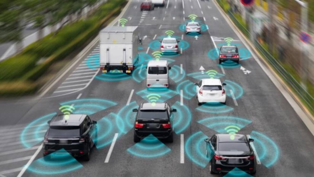 An overhead view of multiple vehicles on a highway, with digital signals indicating connected car technology and communication.