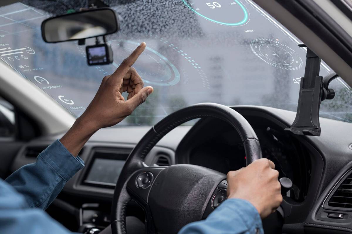  Person using advanced holographic car interface while driving in rain.