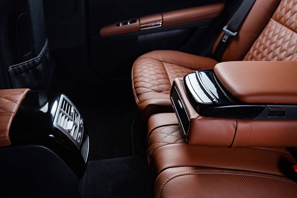 Luxurious car interior with quilted tan leather seats and modern center console.