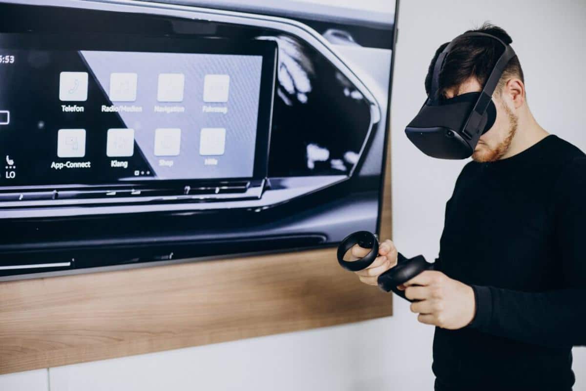 A person wearing a VR headset interacts with a virtual interface displayed on a screen, featuring various app icons.